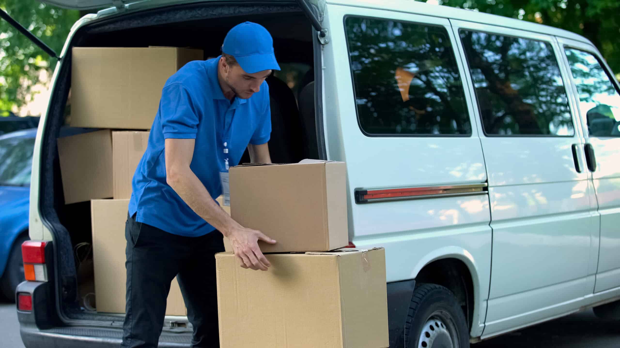 Courier unloading customer shipments from a delivery van