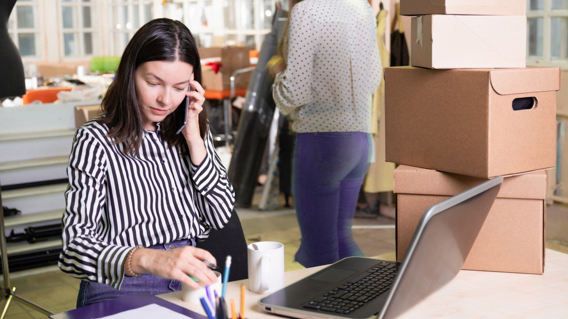 Woman on phone with laptop 1152