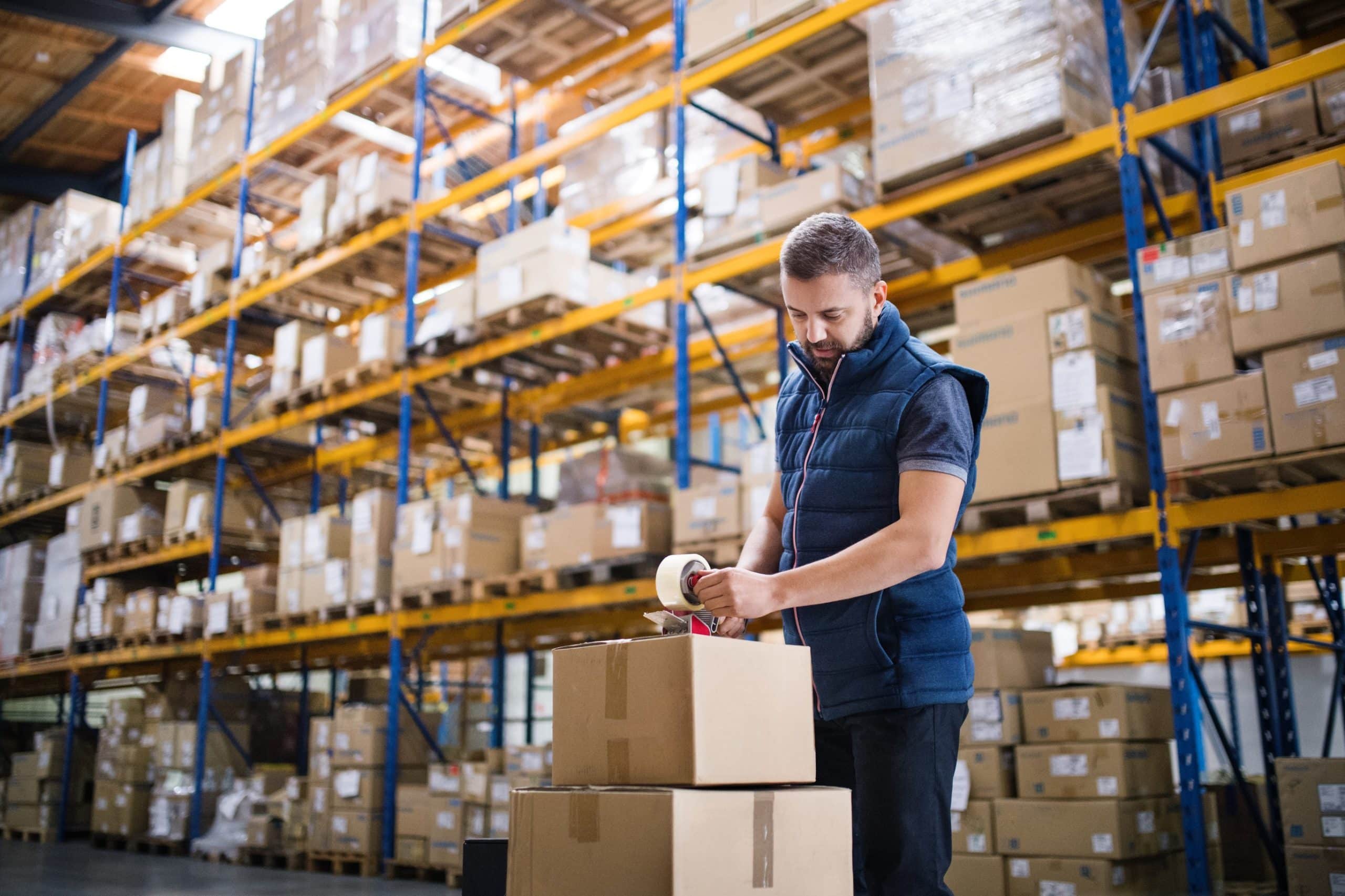 Cartons being packed and labelled in a warehouse